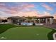 Entertainer's backyard with a pool, putting green, and covered patio; a perfect oasis at 9911 W Jessie Ln, Peoria, AZ 85383