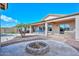 Landscaped backyard with a fire pit and a view of the pool at 9911 W Jessie Ln, Peoria, AZ 85383