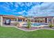 Spacious backyard with a pool, hot tub, and entertainment area at 9911 W Jessie Ln, Peoria, AZ 85383