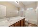 Clean bathroom features a vanity, white tile shower and a toilet at 9911 W Jessie Ln, Peoria, AZ 85383