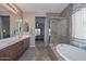 Elegant bathroom with double sinks, shower, and tub at 9911 W Jessie Ln, Peoria, AZ 85383