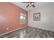 Well-lit bedroom featuring wood-look floors and a ceiling fan at 9911 W Jessie Ln, Peoria, AZ 85383
