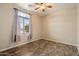 Simple bedroom features a window, neutral wall paint, and wood-look floors at 9911 W Jessie Ln, Peoria, AZ 85383