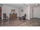 Entryway with hardwood floors, a wooden cabinet, and leather seating at 9911 W Jessie Ln, Peoria, AZ 85383