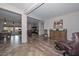 Open floor plan with hardwood floors and a view into the living room and dining area at 9911 W Jessie Ln, Peoria, AZ 85383