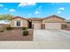 Charming single-story home with a three-car garage and a well-maintained landscaped front yard at 9911 W Jessie Ln, Peoria, AZ 85383
