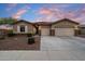 Charming single-story home with a three-car garage and a well-maintained landscaped front yard at 9911 W Jessie Ln, Peoria, AZ 85383
