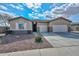 One-story house with a three-car garage and desert landscaping at 9911 W Jessie Ln, Peoria, AZ 85383