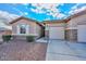 Front view of the house with a two-car garage and walkway at 9911 W Jessie Ln, Peoria, AZ 85383