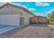 Side view of the house, showcasing the garage and gate at 9911 W Jessie Ln, Peoria, AZ 85383