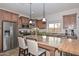 Island kitchen with granite counters and wood cabinets at 9911 W Jessie Ln, Peoria, AZ 85383