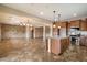 Open floor plan featuring a kitchen with stainless steel appliances and an island with seating at 9911 W Jessie Ln, Peoria, AZ 85383