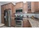 Well-equipped kitchen boasting stainless steel appliances and wood cabinets at 9911 W Jessie Ln, Peoria, AZ 85383