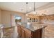 Open kitchen with granite countertops, a central island, and modern stainless steel appliances at 9911 W Jessie Ln, Peoria, AZ 85383