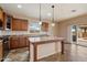 Open kitchen with granite countertops, a central island, and modern stainless steel appliances at 9911 W Jessie Ln, Peoria, AZ 85383