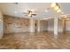 Spacious living room featuring an accent stone wall and open floor plan for easy entertaining at 9911 W Jessie Ln, Peoria, AZ 85383