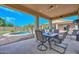 Covered patio with seating area, overlooking a refreshing pool and backyard at 9911 W Jessie Ln, Peoria, AZ 85383