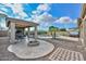 Outdoor patio with stone fireplace and seating area at 9911 W Jessie Ln, Peoria, AZ 85383
