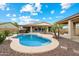Beautiful backyard featuring a sparkling pool, spa, and covered patio for outdoor entertaining at 9911 W Jessie Ln, Peoria, AZ 85383