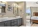 Modern bathroom with double sinks, marble countertop, and view of bedroom at 10222 E Southwind Ln # 1066, Scottsdale, AZ 85262