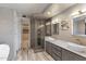 Modern bathroom with double sinks, marble countertop, and walk-in shower at 10222 E Southwind Ln # 1066, Scottsdale, AZ 85262