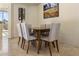 Bright dining area with a wood table and six light grey chairs at 10222 E Southwind Ln # 1066, Scottsdale, AZ 85262