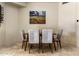 Dining area featuring a wood table and six light grey chairs at 10222 E Southwind Ln # 1066, Scottsdale, AZ 85262