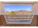 Scenic view of desert landscape with distant homes from a window at 10222 E Southwind Ln # 1066, Scottsdale, AZ 85262