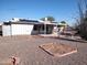 Backyard view, showing patio, gravel, and solar panels at 11001 W Connecticut Ave, Sun City, AZ 85351