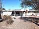 Backyard with patio, gravel landscaping, and solar panels at 11001 W Connecticut Ave, Sun City, AZ 85351