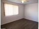 Simple bedroom with dark laminate flooring and window coverings at 11001 W Connecticut Ave, Sun City, AZ 85351