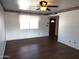 Bright living room with dark laminate floors and ceiling fan at 11001 W Connecticut Ave, Sun City, AZ 85351