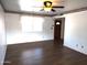 Bright living room featuring wood-look floors and a ceiling fan at 11001 W Connecticut Ave, Sun City, AZ 85351