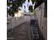 Small backyard with gravel, a fruit tree, and a white fence at 11411 N 91St Ave # 80, Peoria, AZ 85345