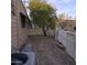 Small backyard with gravel, a fruit tree, and a white fence at 11411 N 91St Ave # 80, Peoria, AZ 85345