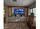 Living room with built-in entertainment center and large TV at 11411 N 91St Ave # 80, Peoria, AZ 85345