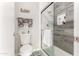 Modern bathroom featuring a glass shower with gray wood-like tile and a white toilet at 11427 S Tomah St, Phoenix, AZ 85044