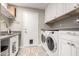 Well-equipped laundry room with sink, counterspace, cabinets, and modern washer and dryer at 11427 S Tomah St, Phoenix, AZ 85044