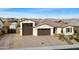 Aerial view of a single-story home with a three-car garage, desert landscaping, and a tile roof at 12528 W Tuckey Ln, Glendale, AZ 85307