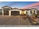 Lovely single-story home showcasing a well-manicured front yard, stone accents, and a spacious three-car garage at 12528 W Tuckey Ln, Glendale, AZ 85307