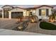 Charming single-story home featuring professional desert landscaping, stone accents, and a three-car garage at 12528 W Tuckey Ln, Glendale, AZ 85307