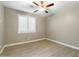 Bright bedroom featuring wood-look floors and a ceiling fan at 12528 W Tuckey W Ln, Glendale, AZ 85307