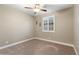 Well-lit bedroom with ceiling fan and plush carpeting at 12528 W Tuckey W Ln, Glendale, AZ 85307