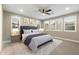 Comfortable bedroom featuring a plush bed with decorative pillows, a ceiling fan, and bright natural light at 12528 W Tuckey W Ln, Glendale, AZ 85307