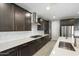 Well-lit kitchen features dark cabinets, stainless steel appliances, and a stylish subway tile backsplash at 12528 W Tuckey W Ln, Glendale, AZ 85307