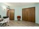 Bright bedroom with wood-look floors and access to hallway at 14017 N 111Th Ave, Sun City, AZ 85351