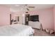 Bedroom with pink walls, queen bed, and built-in dresser at 14017 N 111Th Ave, Sun City, AZ 85351