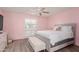 Pink walls and a queen-size bed highlight this spacious bedroom at 14017 N 111Th Ave, Sun City, AZ 85351