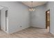 Simple dining room with light gray walls and wood-look flooring at 14017 N 111Th Ave, Sun City, AZ 85351