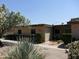 Tan, single-story home with shrubs at 14017 N 111Th Ave, Sun City, AZ 85351